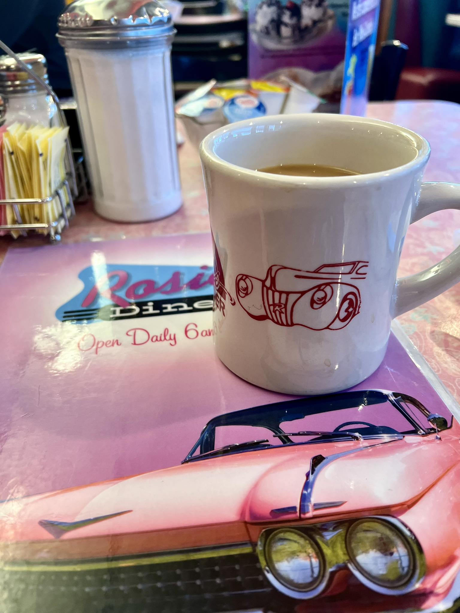 Steaming hot coffee in a branded Rosie's Diner mug